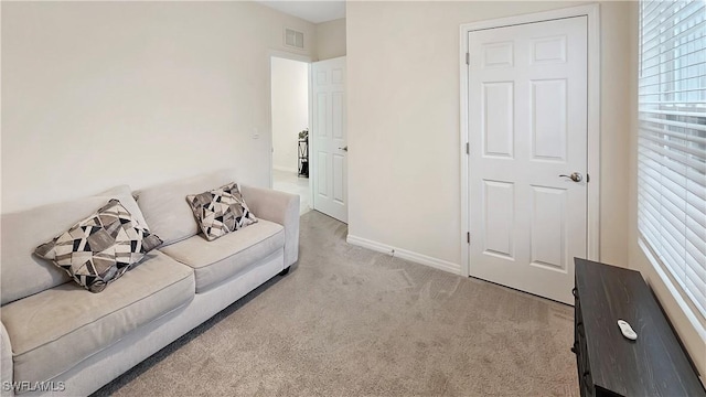 living room featuring light carpet, visible vents, and baseboards