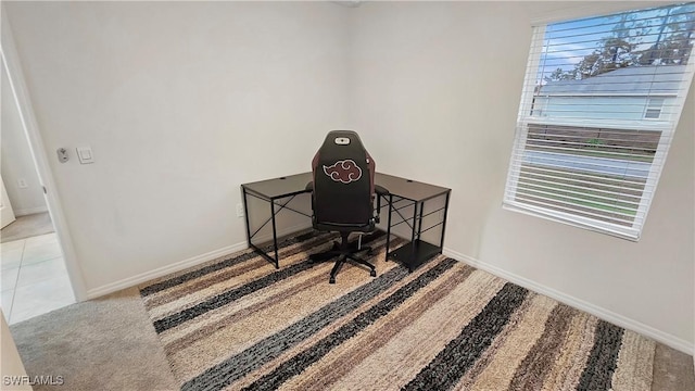 office area with light carpet, light tile patterned floors, and baseboards