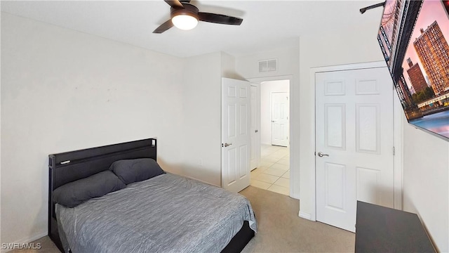 carpeted bedroom with visible vents and ceiling fan