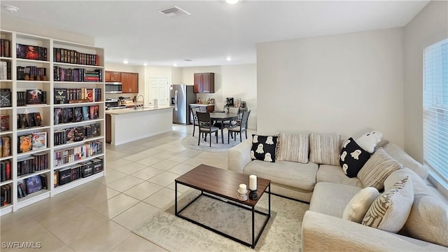 living room featuring light tile patterned floors, visible vents, and recessed lighting