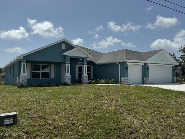106 SE 5th Ave, Cape Coral, FL 33990 - view of front of home featuring an attached garage, a front yard, stone siding, concrete driveway, and roof with shingles