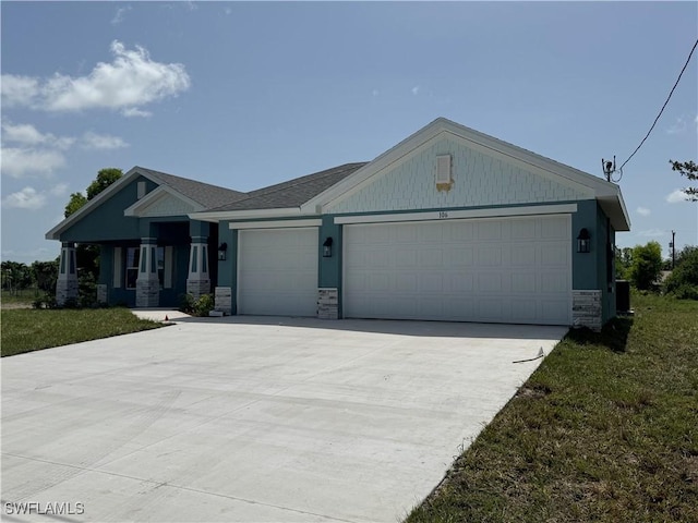 106 SE 5th Ave, Cape Coral, FL 33990 - view of front of property with stone siding, a garage, and concrete driveway