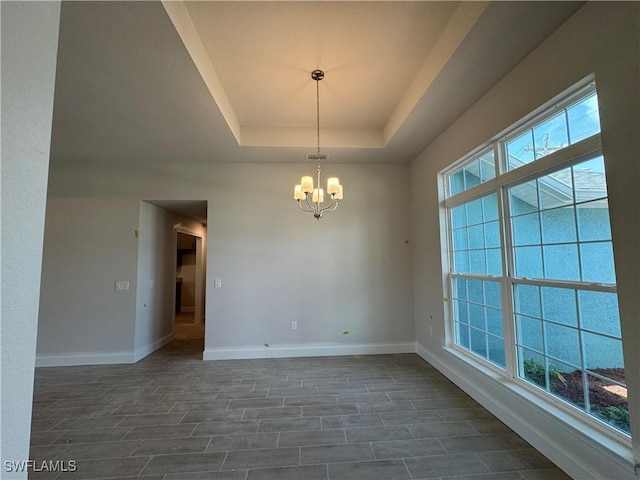 106 SE 5th Ave, Cape Coral, FL 33990 - empty room featuring a chandelier, baseboards, and a raised ceiling