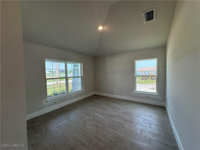 106 SE 5th Ave, Cape Coral, FL 33990 - spare room with lofted ceiling, healthy amount of natural light, and baseboards