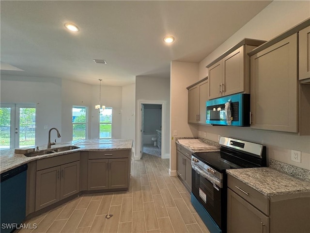 106 SE 5th Ave, Cape Coral, FL 33990 - kitchen with appliances with stainless steel finishes, a sink, gray cabinetry, light stone counters, and recessed lighting