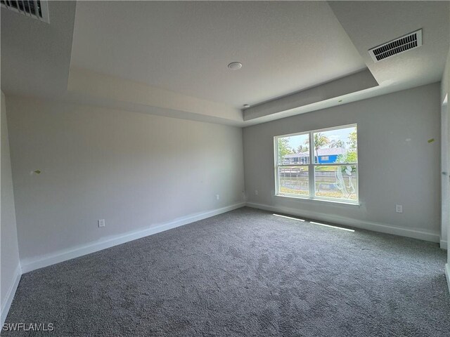 106 SE 5th Ave, Cape Coral, FL 33990 - empty room with a raised ceiling, baseboards, and carpet flooring