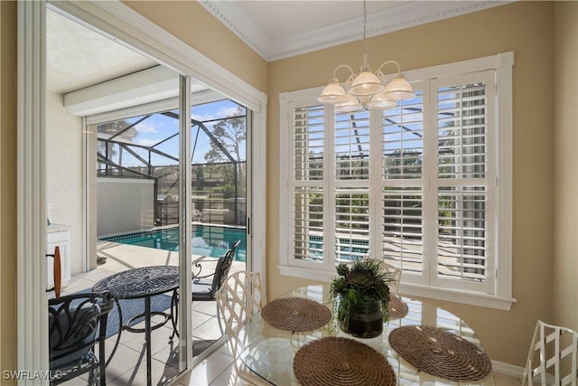 dining space with a chandelier, tile patterned flooring, and crown molding