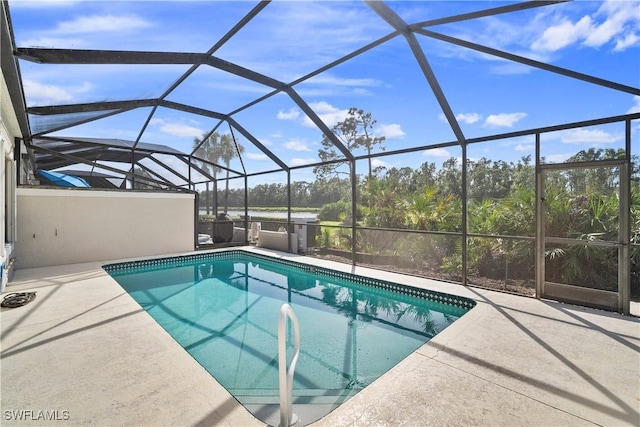 pool featuring a lanai and a patio area