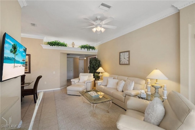 tiled living room with baseboards, visible vents, a ceiling fan, and ornamental molding