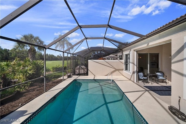 pool with glass enclosure and a patio