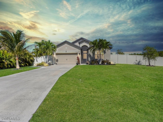 view of front of property with an attached garage, fence, a front lawn, and concrete driveway