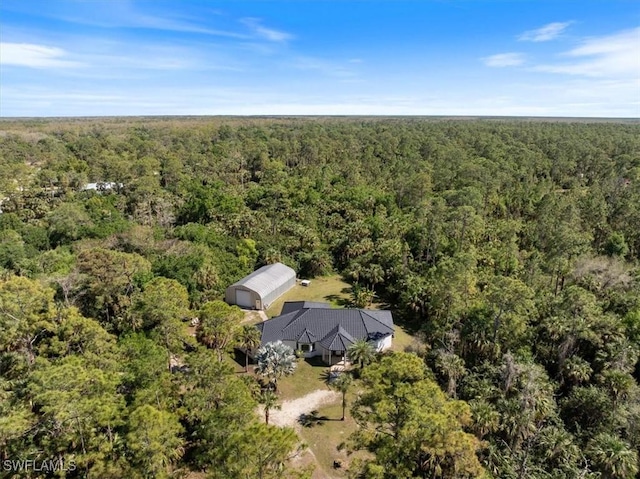 birds eye view of property featuring a wooded view