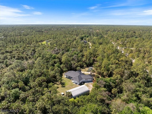 birds eye view of property with a view of trees