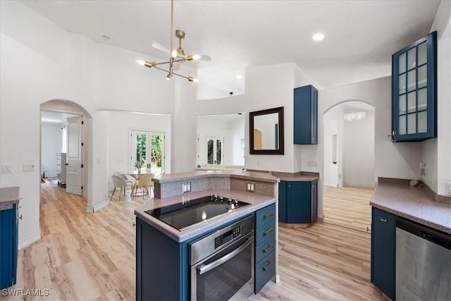 1240 Desoto Blvd S, Naples, FL 34117 - kitchen with blue cabinetry, stainless steel appliances, arched walkways, a chandelier, and recessed lighting