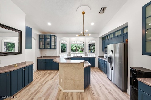 1240 Desoto Blvd S, Naples, FL 34117 - kitchen featuring stainless steel fridge with ice dispenser, blue cabinets, a center island, light wood-type flooring, and glass insert cabinets