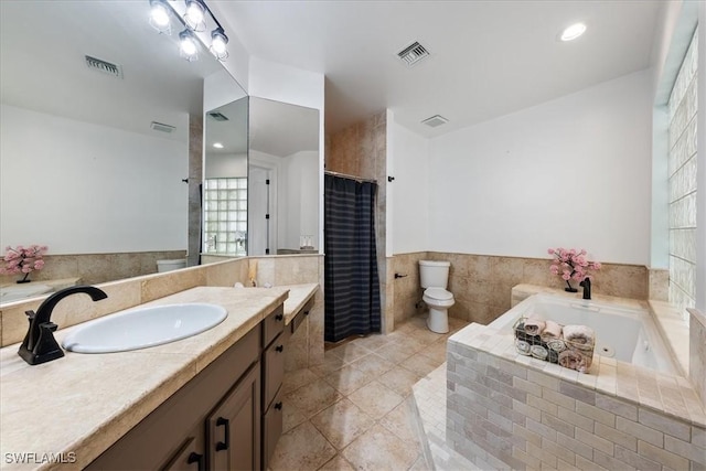 1240 Desoto Blvd S, Naples, FL 34117 - full bathroom with vanity, a tub with jets, tile patterned flooring, plenty of natural light, and wainscoting
