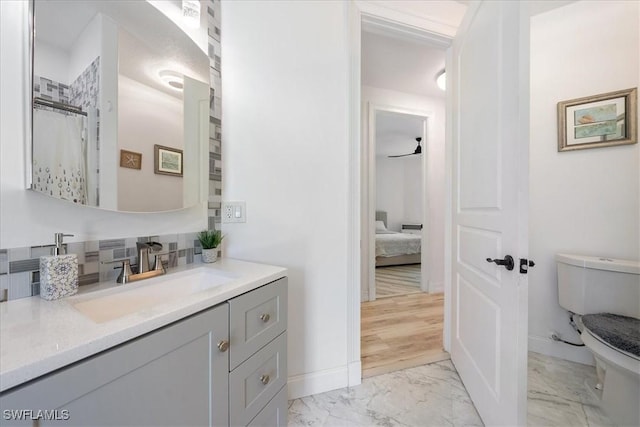 1240 Desoto Blvd S, Naples, FL 34117 - bathroom featuring marble finish flooring, vanity, ensuite bathroom, and backsplash