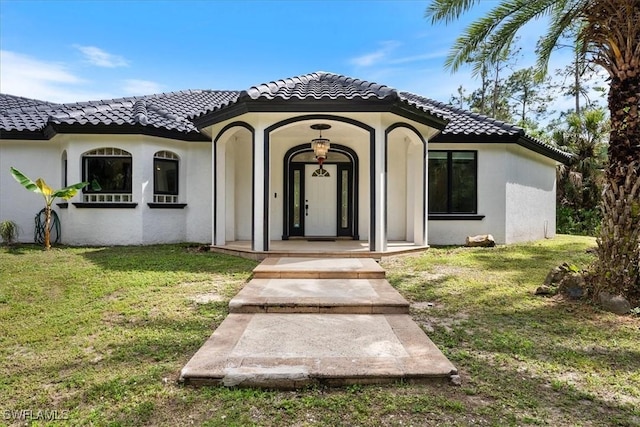 1240 Desoto Blvd S, Naples, FL 34117 - view of front of property with a front lawn, stucco siding, and a tiled roof