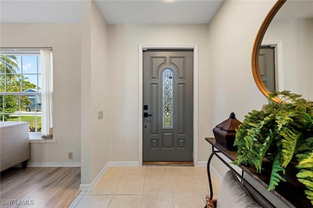 entryway featuring baseboards and light tile patterned floors