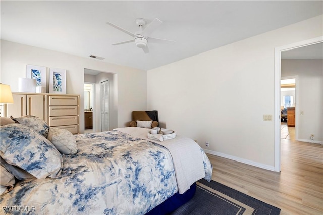 bedroom featuring baseboards, visible vents, ceiling fan, light wood-type flooring, and a closet