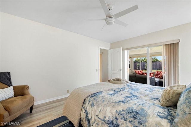 bedroom with access to exterior, a ceiling fan, baseboards, and wood finished floors