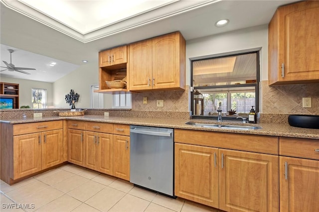 kitchen with light tile patterned floors, light stone counters, a peninsula, a sink, and dishwasher