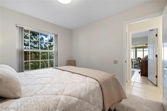 bedroom with light carpet and light tile patterned flooring