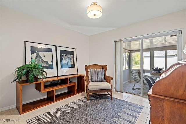 sitting room with baseboards and light tile patterned floors