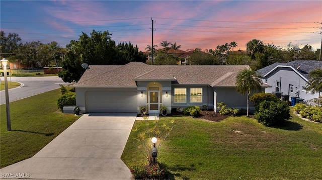 ranch-style house featuring a front yard, driveway, an attached garage, and stucco siding