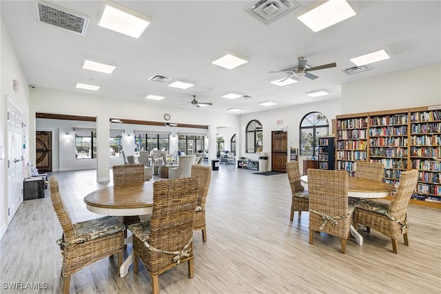 dining area with light wood-style floors and visible vents