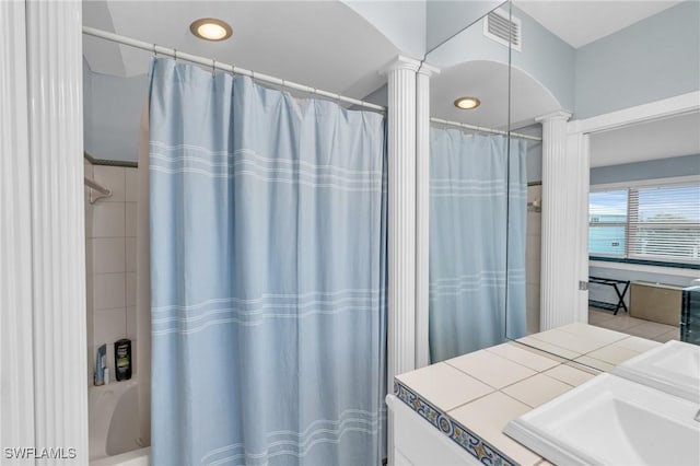 8080 Lagoon Rd, Fort Myers Beach, FL 33931 - bathroom with ornate columns, a sink, shower / bathtub combination with curtain, and recessed lighting