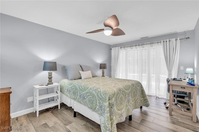8080 Lagoon Rd, Fort Myers Beach, FL 33931 - bedroom featuring wood finished floors, an office area, a ceiling fan, and baseboards