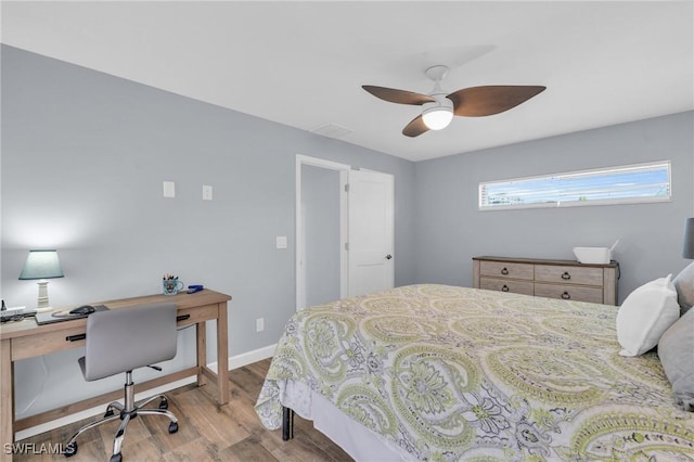 8080 Lagoon Rd, Fort Myers Beach, FL 33931 - bedroom featuring wood finished floors, a desk, a ceiling fan, and baseboards