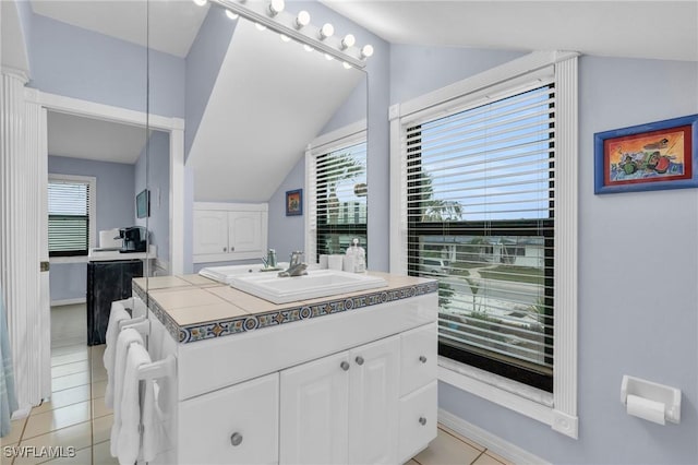 8080 Lagoon Rd, Fort Myers Beach, FL 33931 - bathroom featuring lofted ceiling, vanity, tile patterned floors, and baseboards