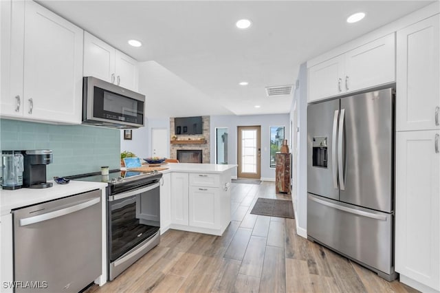 8080 Lagoon Rd, Fort Myers Beach, FL 33931 - kitchen featuring stainless steel appliances, a peninsula, white cabinets, light countertops, and open floor plan