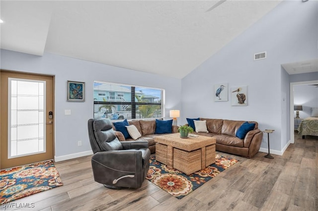 8080 Lagoon Rd, Fort Myers Beach, FL 33931 - living area with wood finished floors, baseboards, and high vaulted ceiling