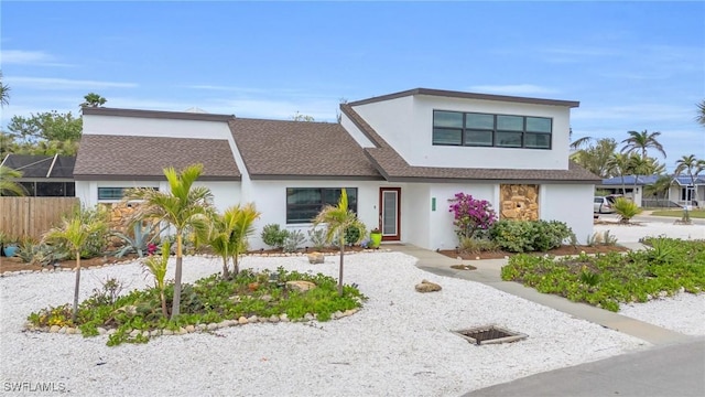 8080 Lagoon Rd, Fort Myers Beach, FL 33931 - contemporary home with stucco siding, roof with shingles, and fence