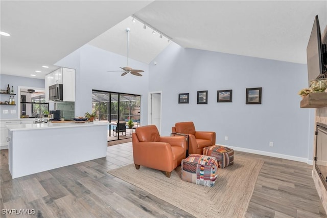 8080 Lagoon Rd, Fort Myers Beach, FL 33931 - living area with ceiling fan, light wood finished floors, baseboards, recessed lighting, and high vaulted ceiling