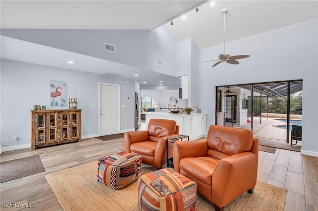 8080 Lagoon Rd, Fort Myers Beach, FL 33931 - living area with light wood-style floors, a ceiling fan, healthy amount of natural light, and high vaulted ceiling