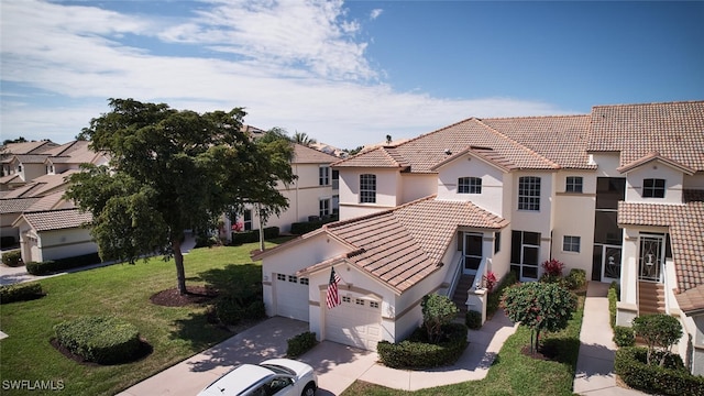 view of front of home with a garage, a residential view, a tiled roof, a front lawn, and stucco siding