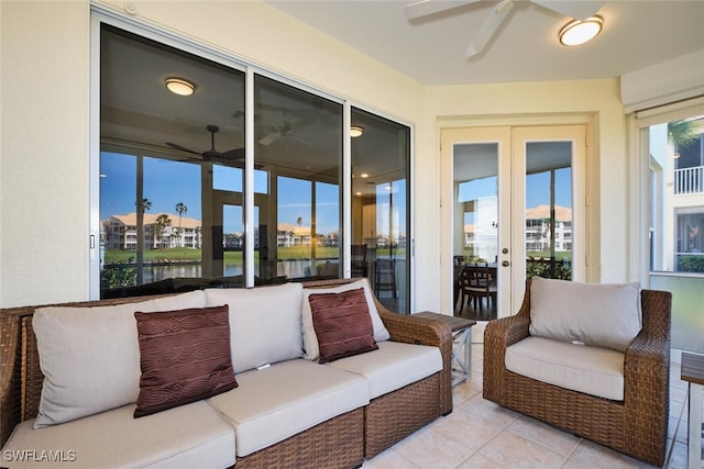 sunroom with a water view and a ceiling fan