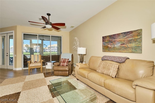 living area with a ceiling fan, visible vents, and wood finished floors