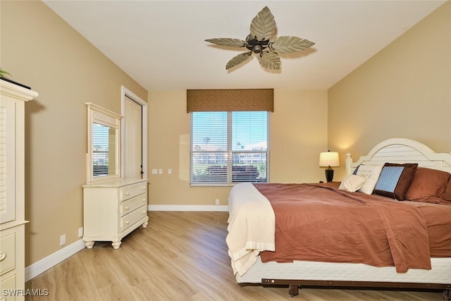 bedroom with light wood finished floors, multiple windows, and baseboards