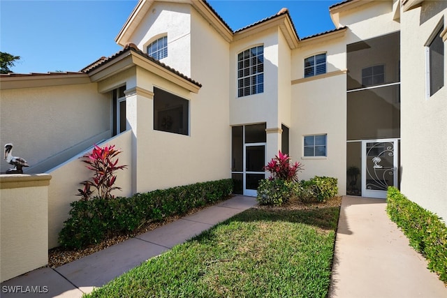 property entrance with stucco siding