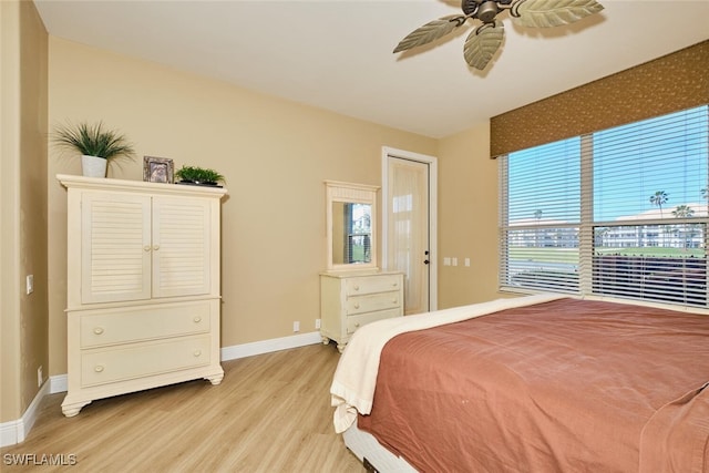 bedroom featuring light wood-type flooring, ceiling fan, and baseboards