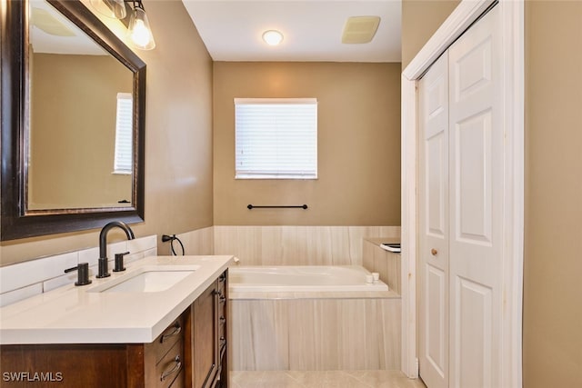 full bath featuring a closet, a garden tub, and vanity