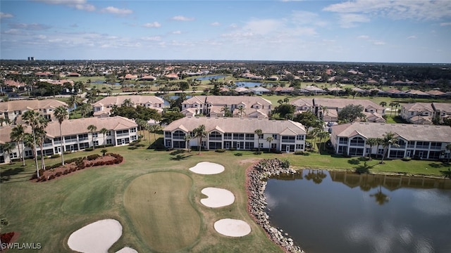 drone / aerial view featuring view of golf course, a water view, and a residential view