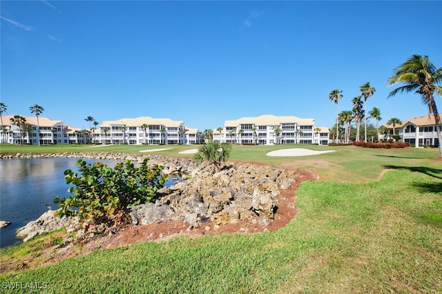 surrounding community with a lawn, a water view, and a residential view