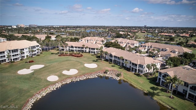 drone / aerial view with a water view, view of golf course, and a residential view