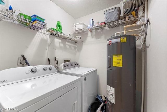 washroom with independent washer and dryer, laundry area, and water heater